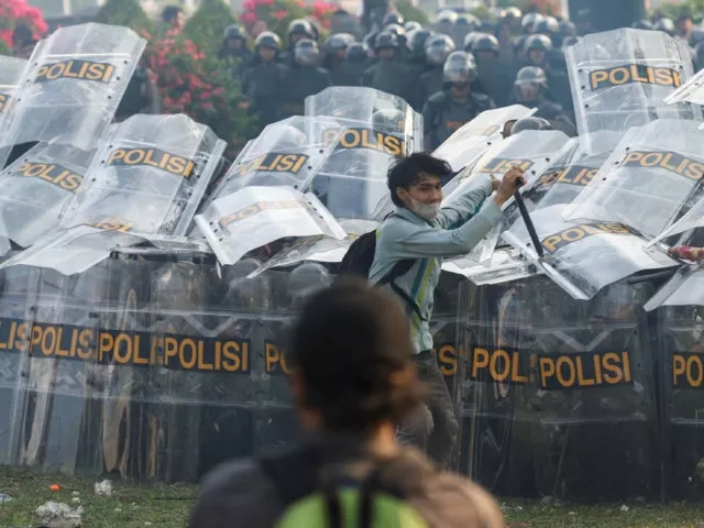riot police hold shields as people protest outside the indonesian parliament against the revisions to the country s election law which analysts believe goes through a rushed process of legislation and is designed to block a popular candidate from running as the capital s governor in jakarta photo reuter